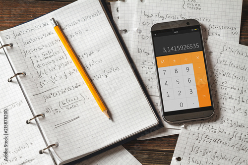 Mathematical equations written in a notebook. Calculator app.
