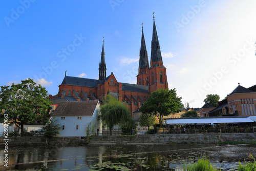 Gorgeous view on town street with cathedral on background. Gorgeous blue sky with white clouds on a summer day. Tourism / travel concept. Europe, Sweden, Uppsala.