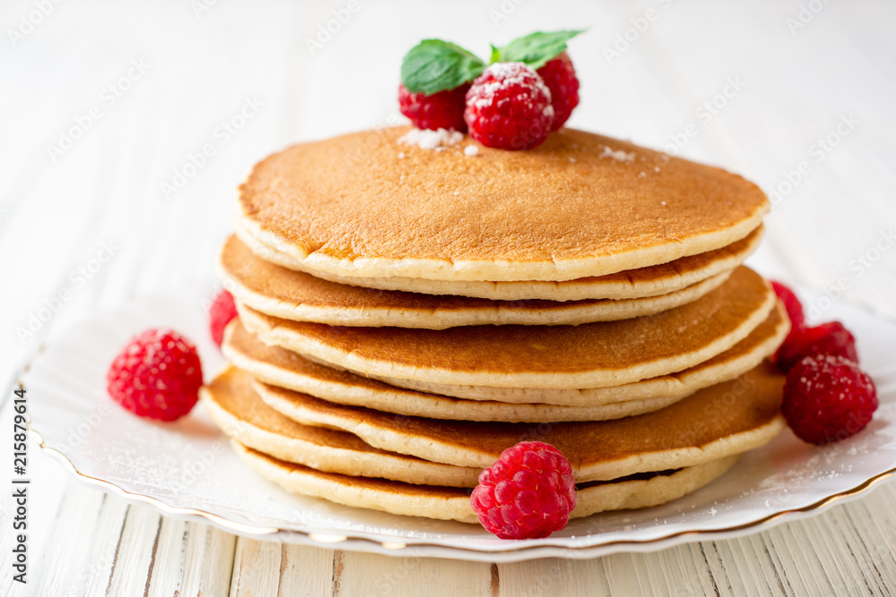 Pancakes with raspberry and mint on white wooden background Pancakes with raspberry and mint on white wooden background