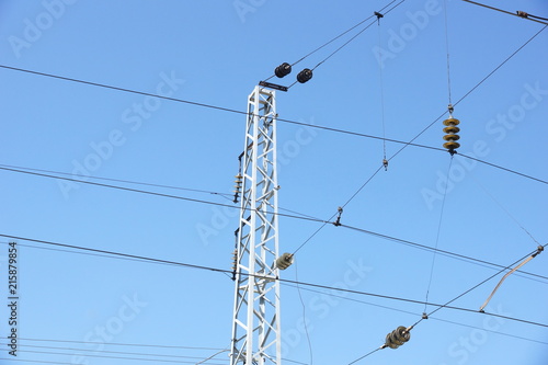 high-voltage power tower against the blue sky