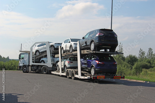 Fotografie, Obraz transportation of new cars on a road train