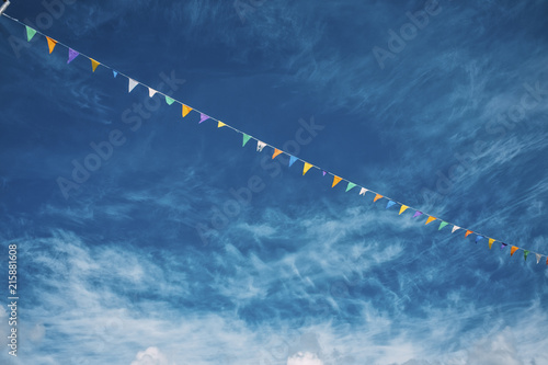 Objects: Colorful banderole against slightly cloudy sky