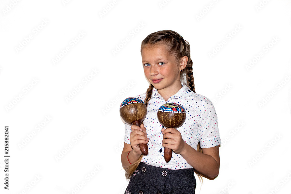 A teenage girl plays maracas. White background. A teenage girl plays maracas. White background.