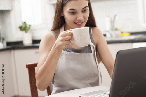 woman reading news at the kitchen