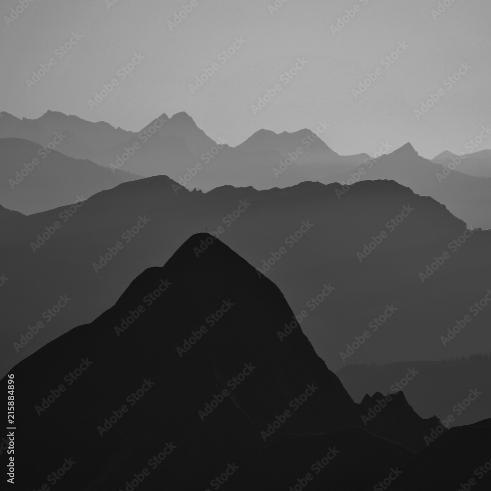 Silhouettes of Mount Tannhorn and other mountains in the Bernese Oberland. View from Mount Brienzer Rothorn.
