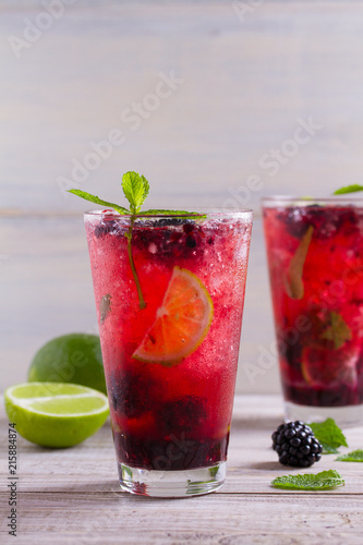 Blackberry mojito cocktail with berries, lime and mint. Summer berry cocktail
