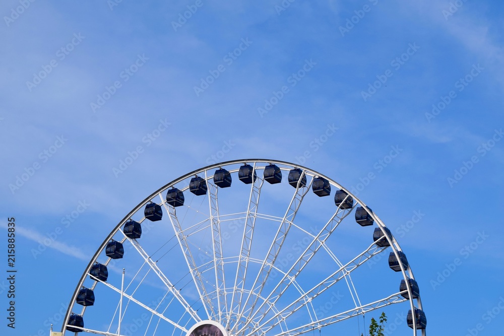 ferris wheel giant top half blue sky soft clouds ferris wheel giant top half blue sky soft clouds