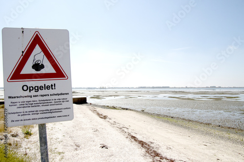 Sign to warn for eating picked up seafood at  the Eastern Scheldt photo
