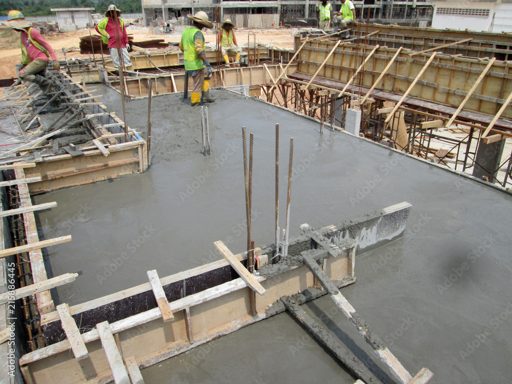 Wet concrete is allowed to harden in wooden form work as the mold