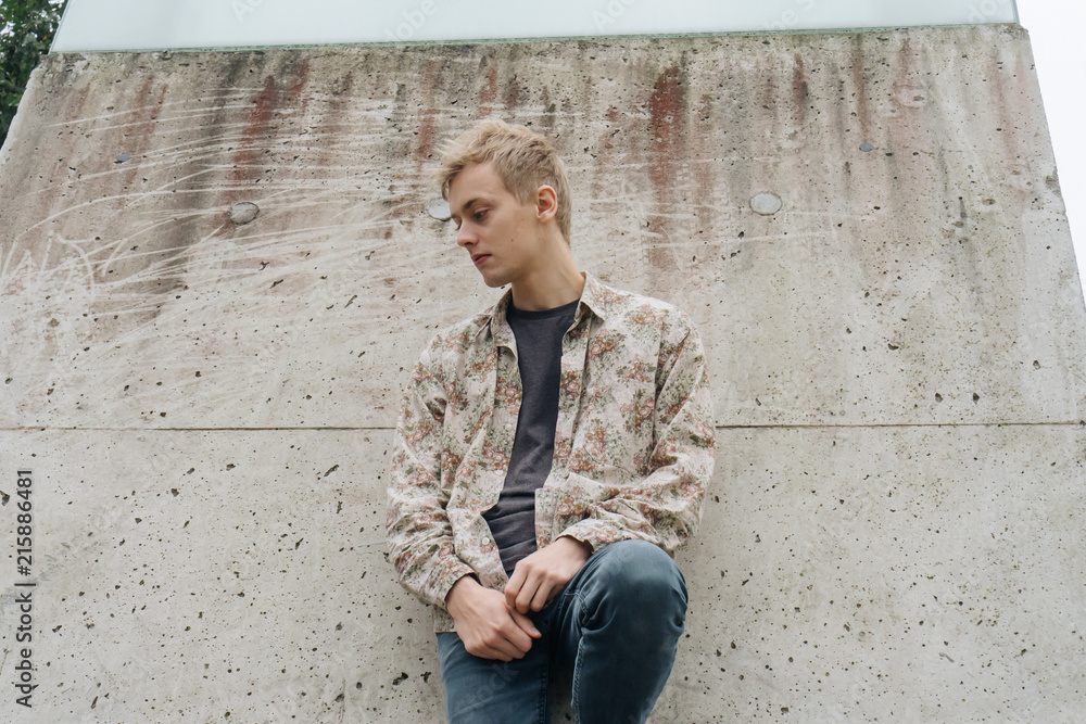 Young man with floral pattern shirt on a cityscape. Young man with floral pattern shirt on a cityscape.