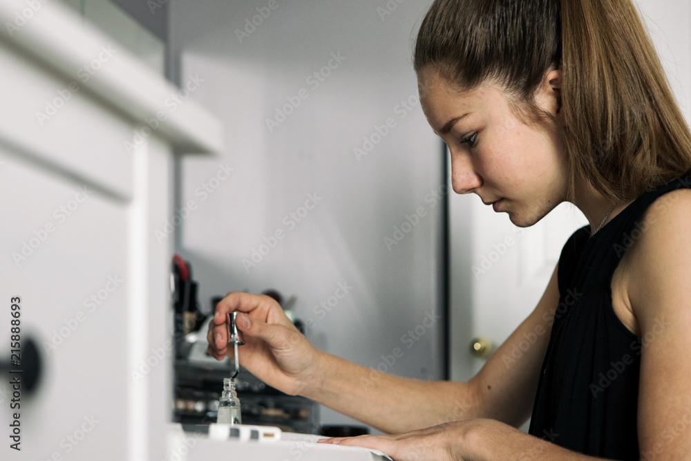 Teenager: Girl Puts Clear Nail Polish On Fingers Teenager: Girl Puts Clear Nail Polish On Fingers