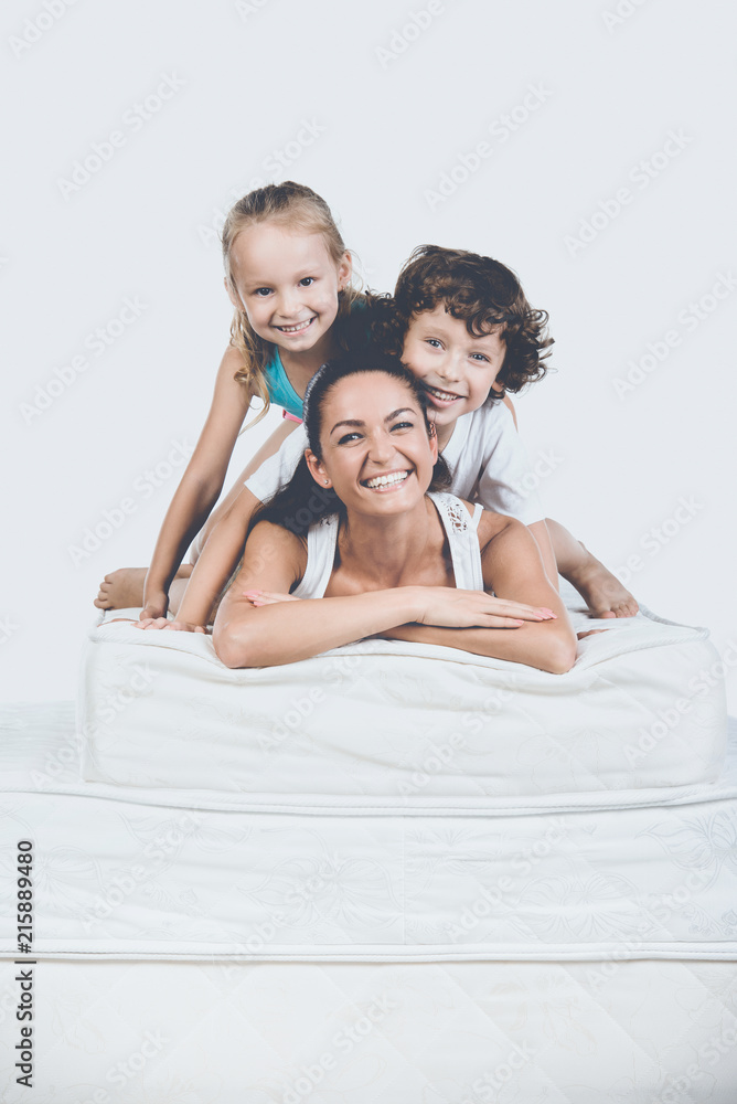Kids with Mother Lying on Pyramid of Mattress