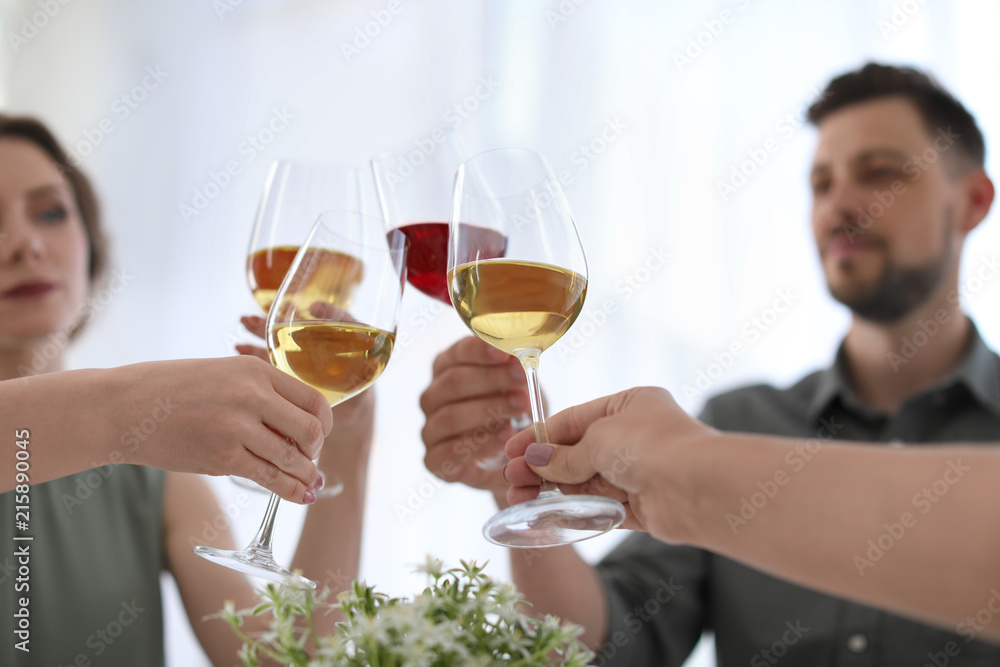 Young people with glasses of delicious wine indoors Young people with glasses of delicious wine indoors