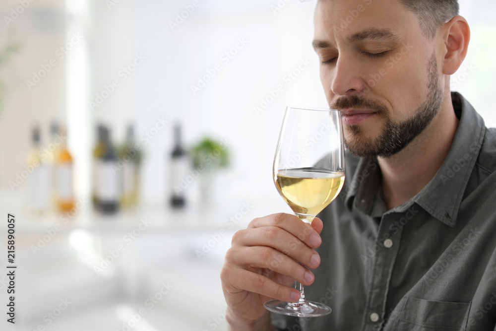Man with glass of delicious wine indoors Man with glass of delicious wine indoors