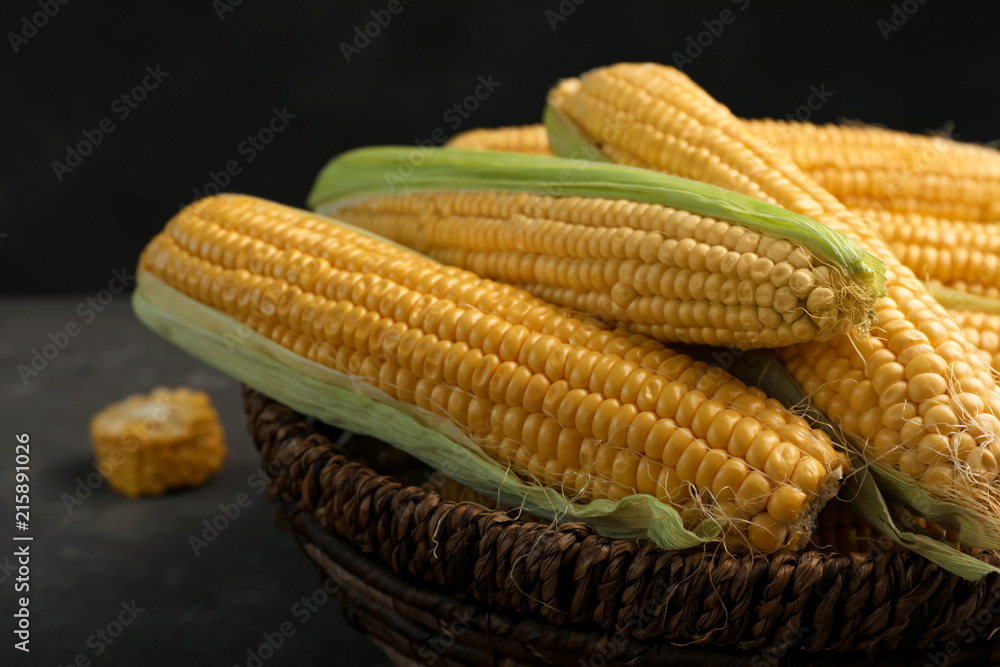 Basket with tasty sweet corn cobs, closeup Basket with tasty sweet corn cobs, closeup