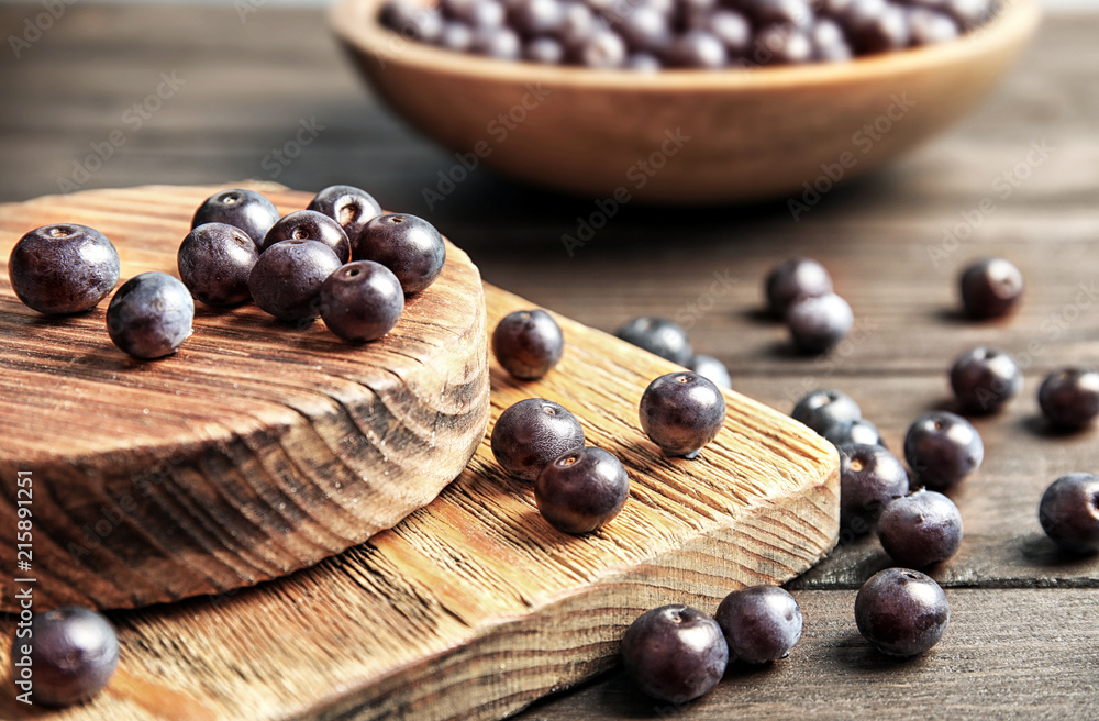 Fresh acai berries on wooden table, closeup Fresh acai berries on wooden table, closeup