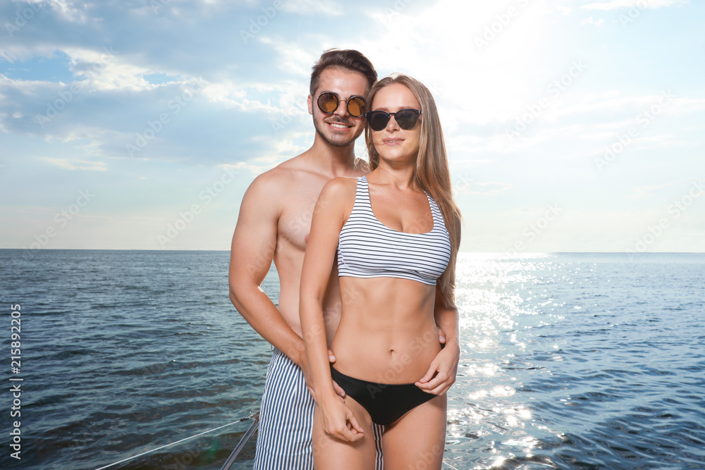 Young man and his beautiful girlfriend in bikini on yacht. Happy couple on  vacation Photos | Adobe Stock