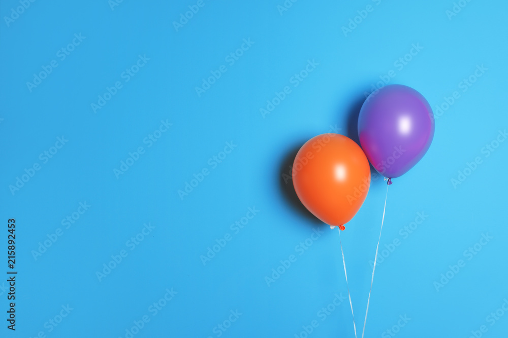 Different balloons on color background. Celebration time