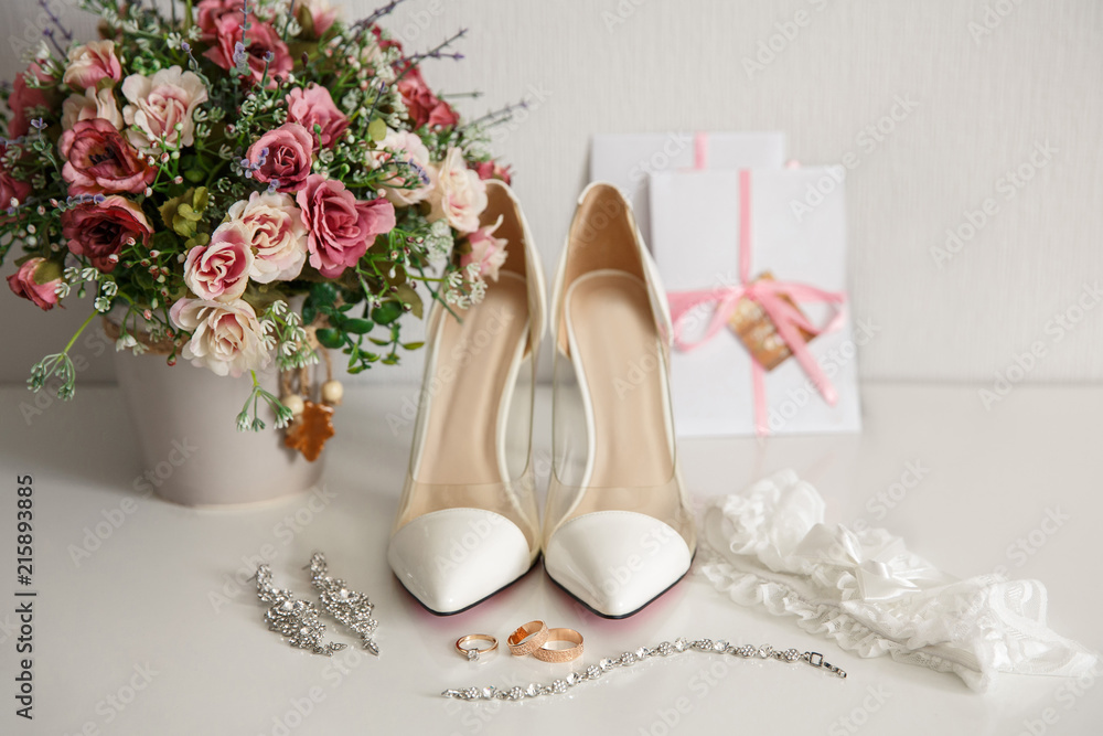 Wedding shoes for bride. White shoes on high heels near wedding