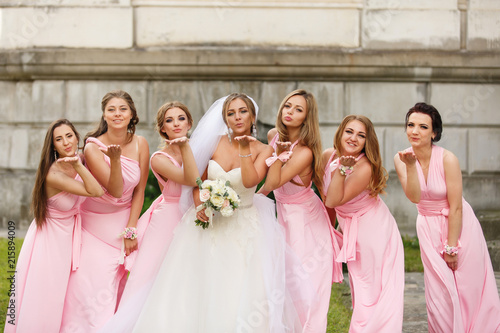 Wedding. Bride and bridesmaids in pink dresses having fun at wedding day. Happy marriage and wedding party concept photo