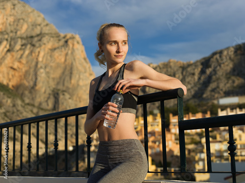 Woman resting with water bottle