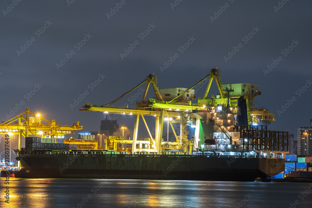 Container cargo ship working at night. import export business logistic and transportation