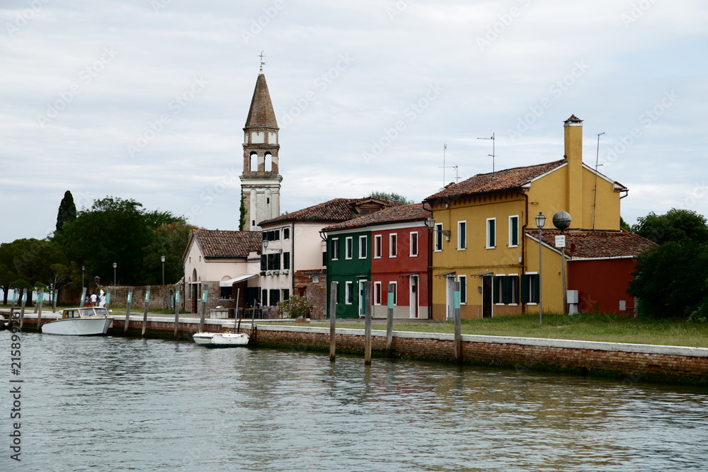 View of the coast from the vaporetto in Burano originally fishermen's town now tourist center. The houses have those striking colors to facilitate their viewing from the sea.