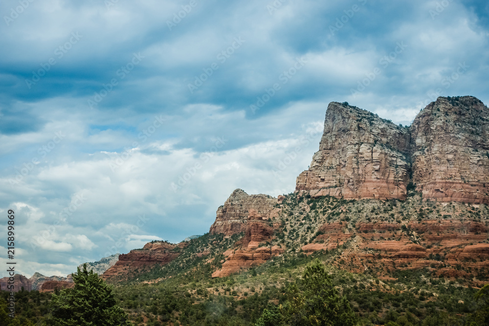 Dramatic butte in Sedona with dramatic storm clouds overhead 