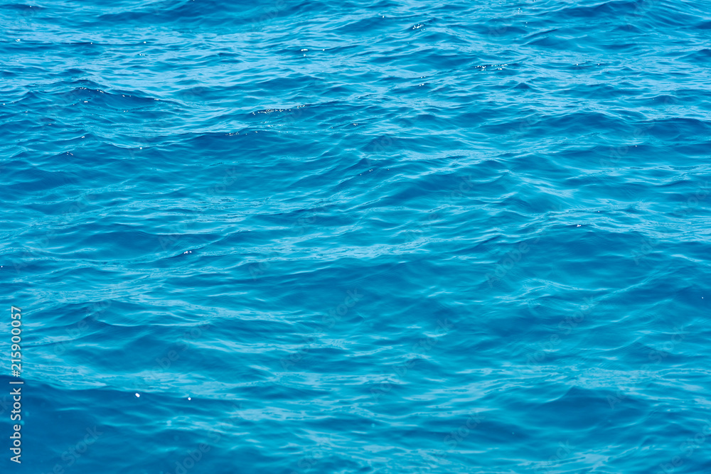 Waving clear blue sea water background.