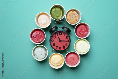 ice cream with a alarmclock on green background
