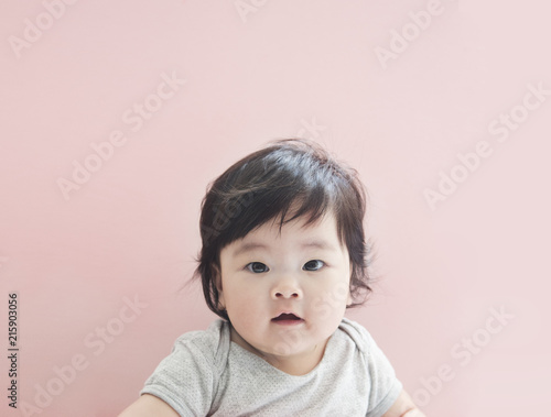 Cute little baby girl with pink background