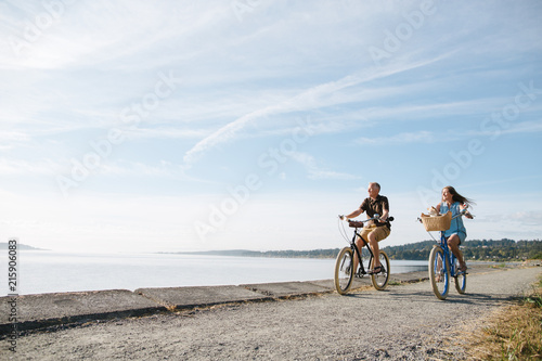 Healthy, active couple enjoying life riding cruiser bikes near o