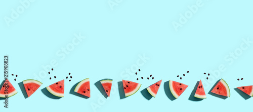Sliced watermelons arranged on a blue background