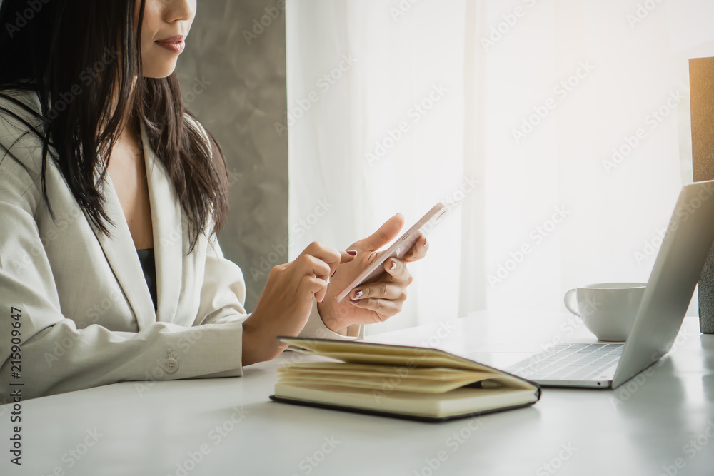 Businesswoman using mobile phone at office. Businesswoman using mobile phone at office.