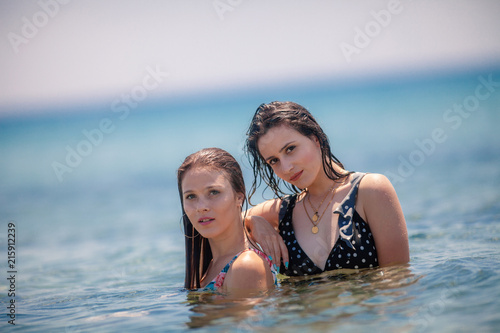 Two Sexy Young Girls having fun at the beach inside the sea