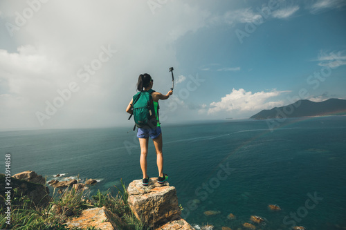 Woman Hiking In Seaside Taking A Selfie