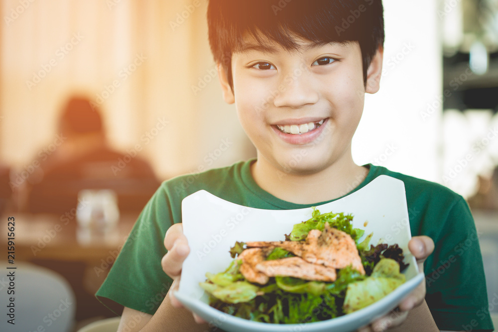 Healthy lifestyle asian child showing salad smiling. Healthy lifestyle asian child showing salad smiling.