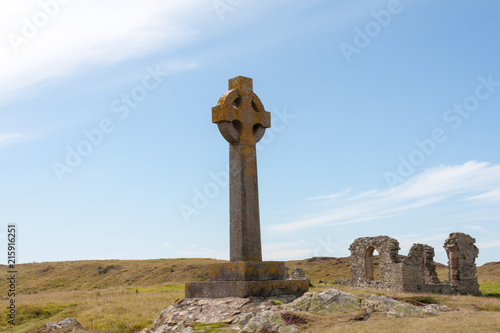 Celtic cross and remains of St Dynwen's church, Llandwyn, Anglesey, Gwynedd, Wales, United Kingdom photo