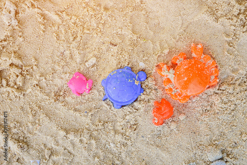 Yellow sand pail and blue shovel.Children's beach toys on the sand.Toys for children sandboxes on the beach, activity for kid. photo