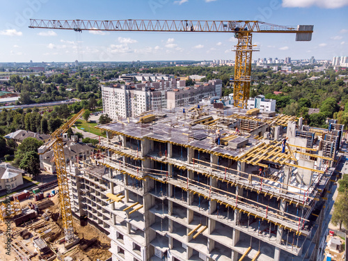 aerial view of the apartment building under construction with cranes