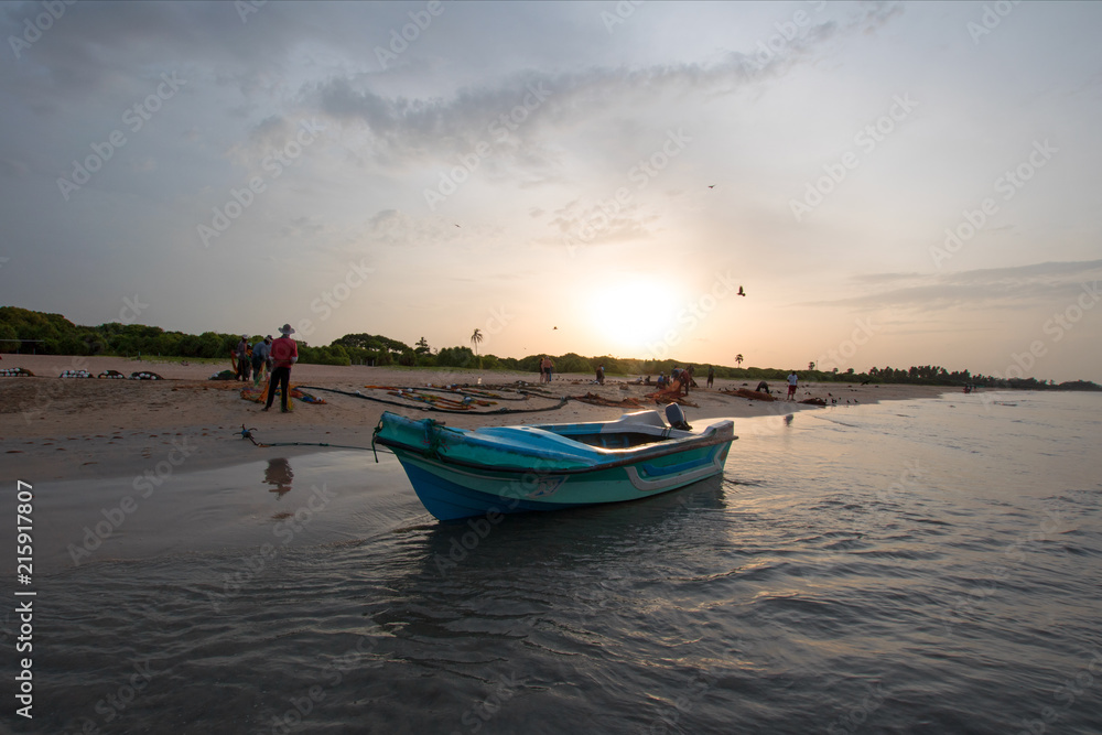 Small fishing boat at twilight sunset on Nilaveli beach in Trincomalee Sri Lanka Asia