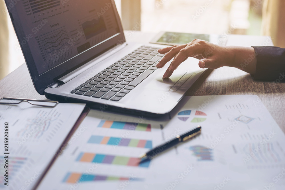 business people working with laptop in office , Notebook laptop and business document on wood table , business concept business people working with laptop in office , Notebook laptop and business document on wood table , business concept