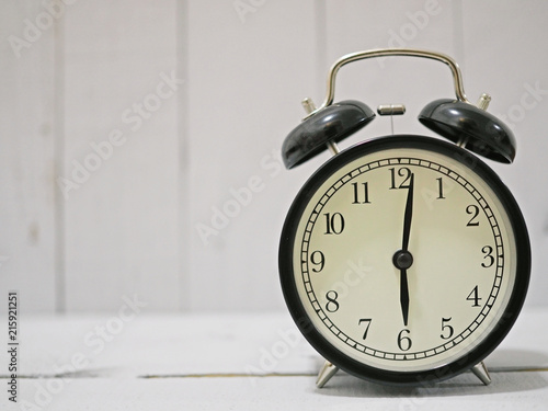alarm clock on white wooden background