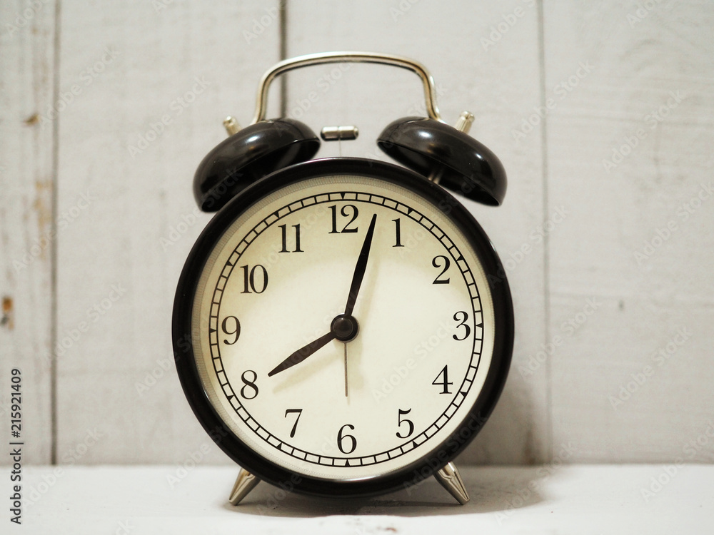 alarm clock on white wooden background alarm clock on white wooden background