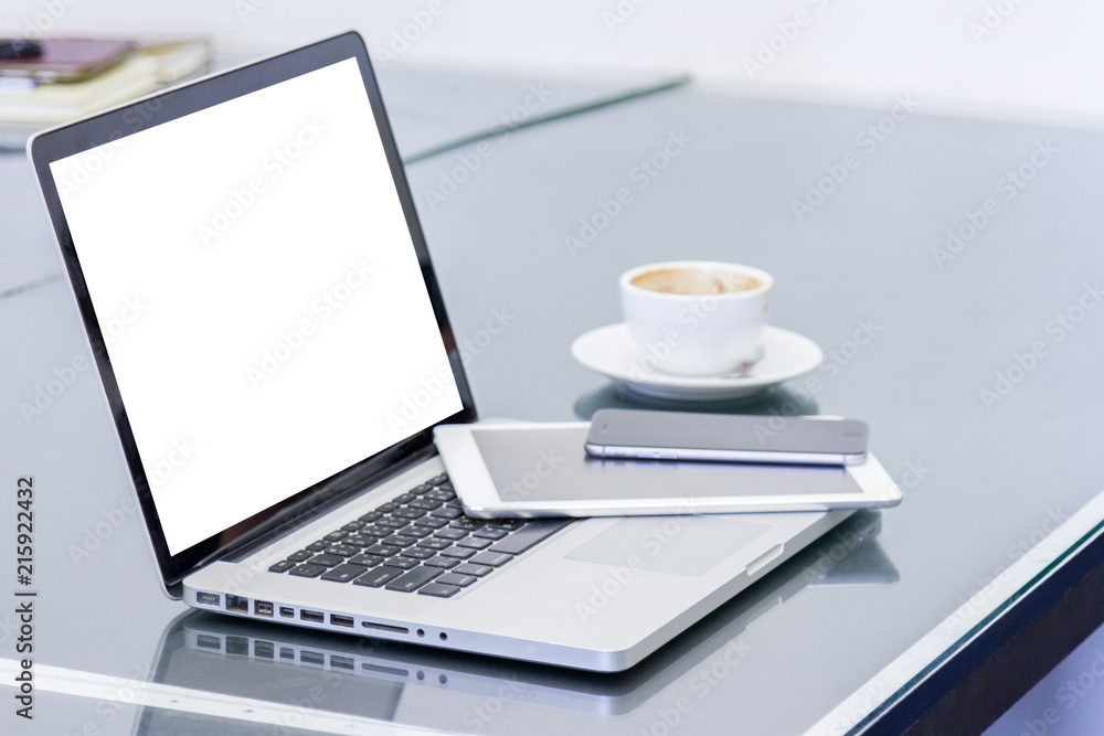 laptop computer with blank white screen and digital tablet on table laptop computer with blank white screen and digital tablet on table