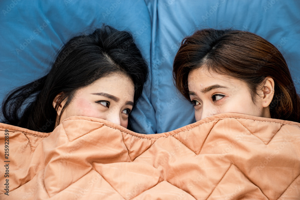 A top view photo close up to couple asian woman are lesbian sleeping ont the blue bed. Couple concept, Lesbian Couple concept