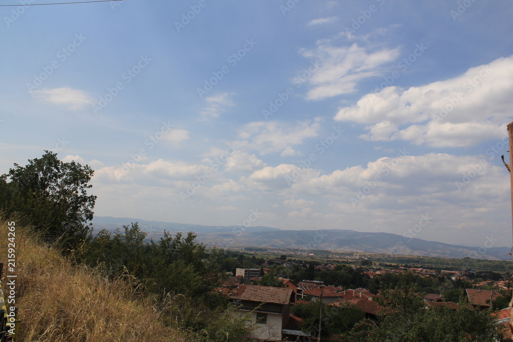 Obraz premium View from the hill to a small town with slate roofs spread out in a mountain valley