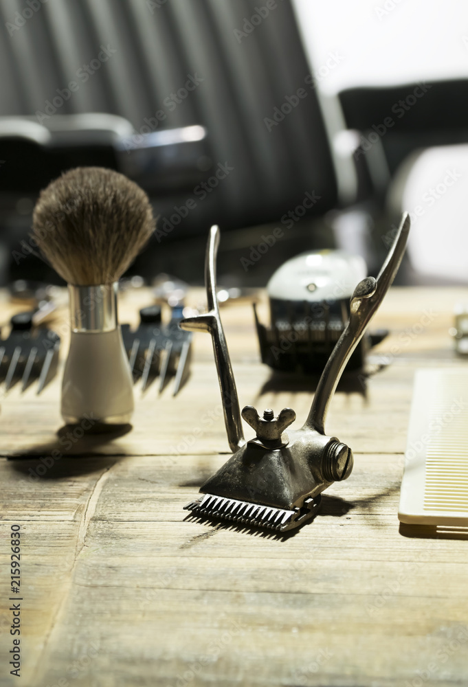 Hair clipper and brush for shaving beard on table in barber shop