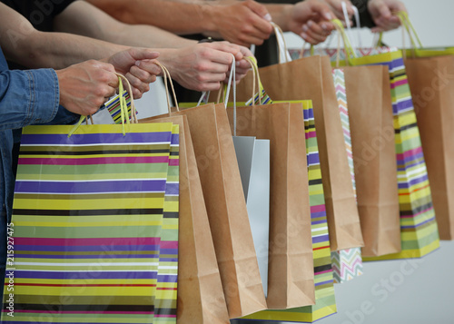 a group of people holds a gift bag.
