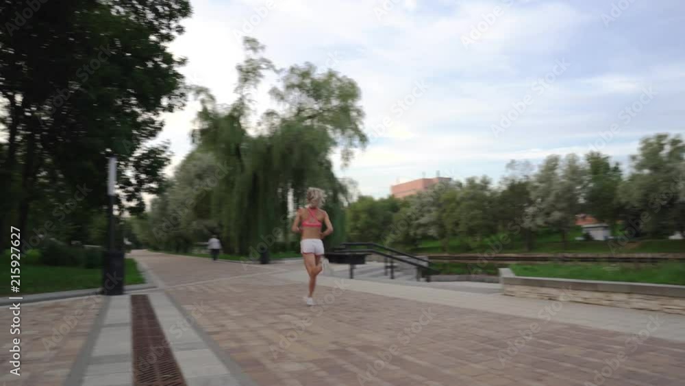 Portrait of handsome woman runing through the park in the morning during sunrise Portrait of handsome woman runing through the park in the morning during sunrise